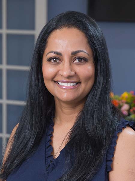 Dr. Sandhya Hegde, lead dentist at Bonita Family Dental in Bonita, CA, smiling in a professional portrait — a Loma Linda University graduate and Fellowship recipient with the Academy of General Dentistry
