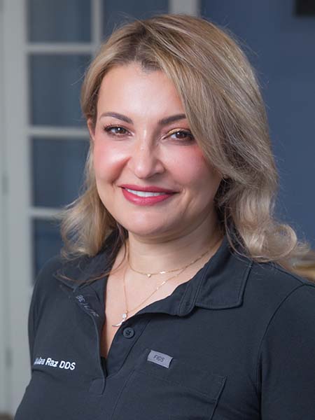 Dr. Walaa Razak, DDS, a dentist at Bonita Family Dental serving patients in Bonita and the surrounding South San Diego communities, shown in a professional portrait in her embroidered scrubs