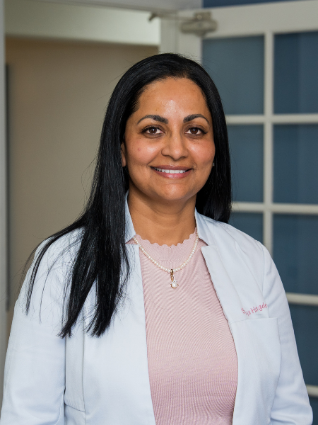 Dr. Sandhya Hegde, lead dentist at Bonita Family Dental in Bonita, CA, smiling in a professional portrait — a Loma Linda University graduate and Fellowship recipient with the Academy of General Dentistry