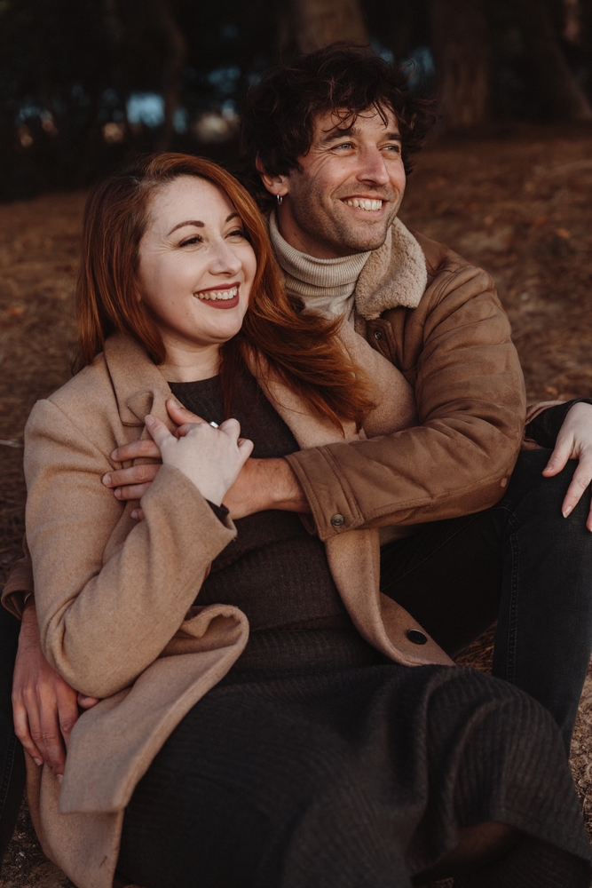 A smiling couple sitting outdoors together, reflecting the confidence and happiness that comes from quality dental care at Bonita Family Dental in South San Diego